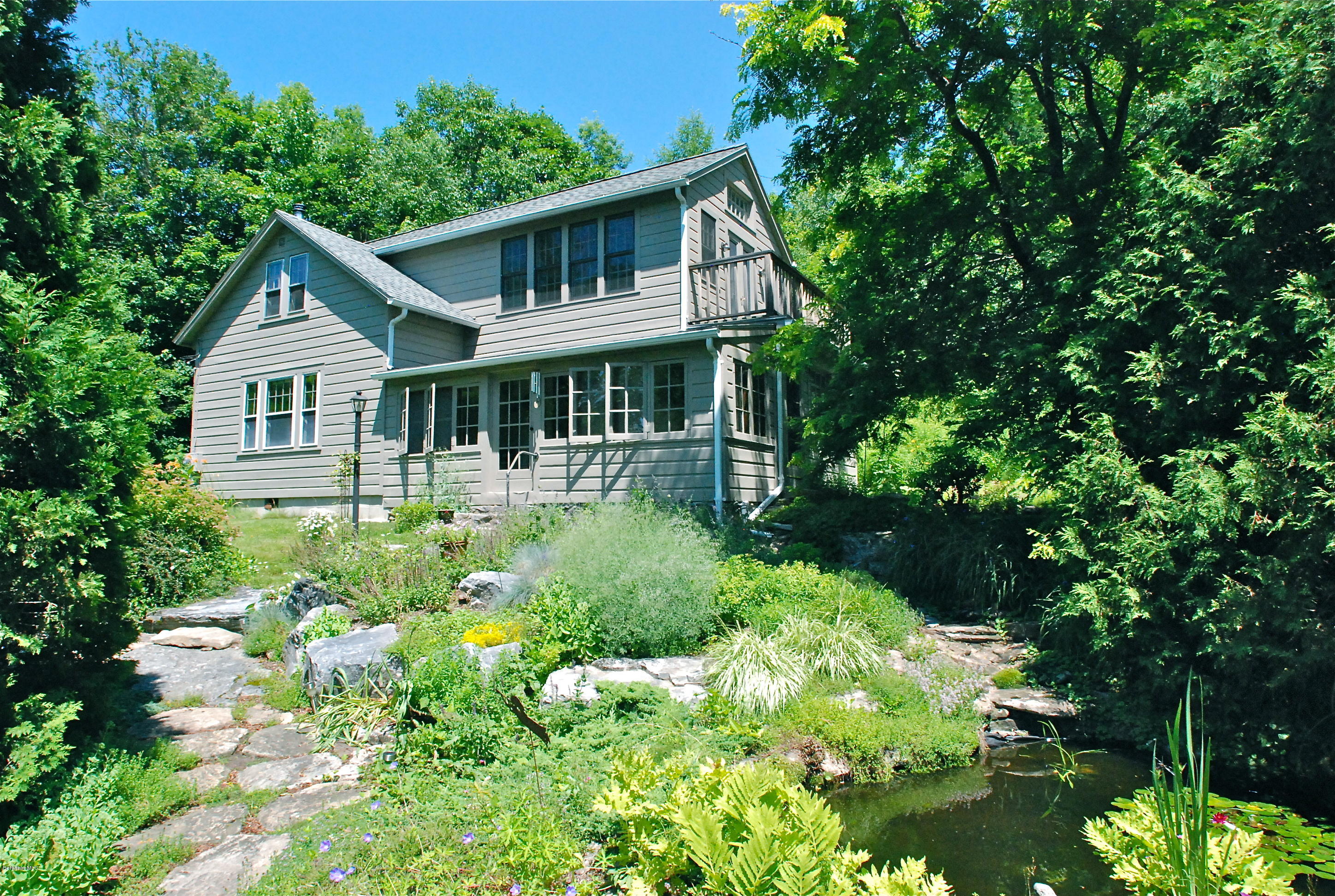 49 River Road Monterey, MA 01245 - Photo 1 of 43 a front view of a house with a yard and fountain