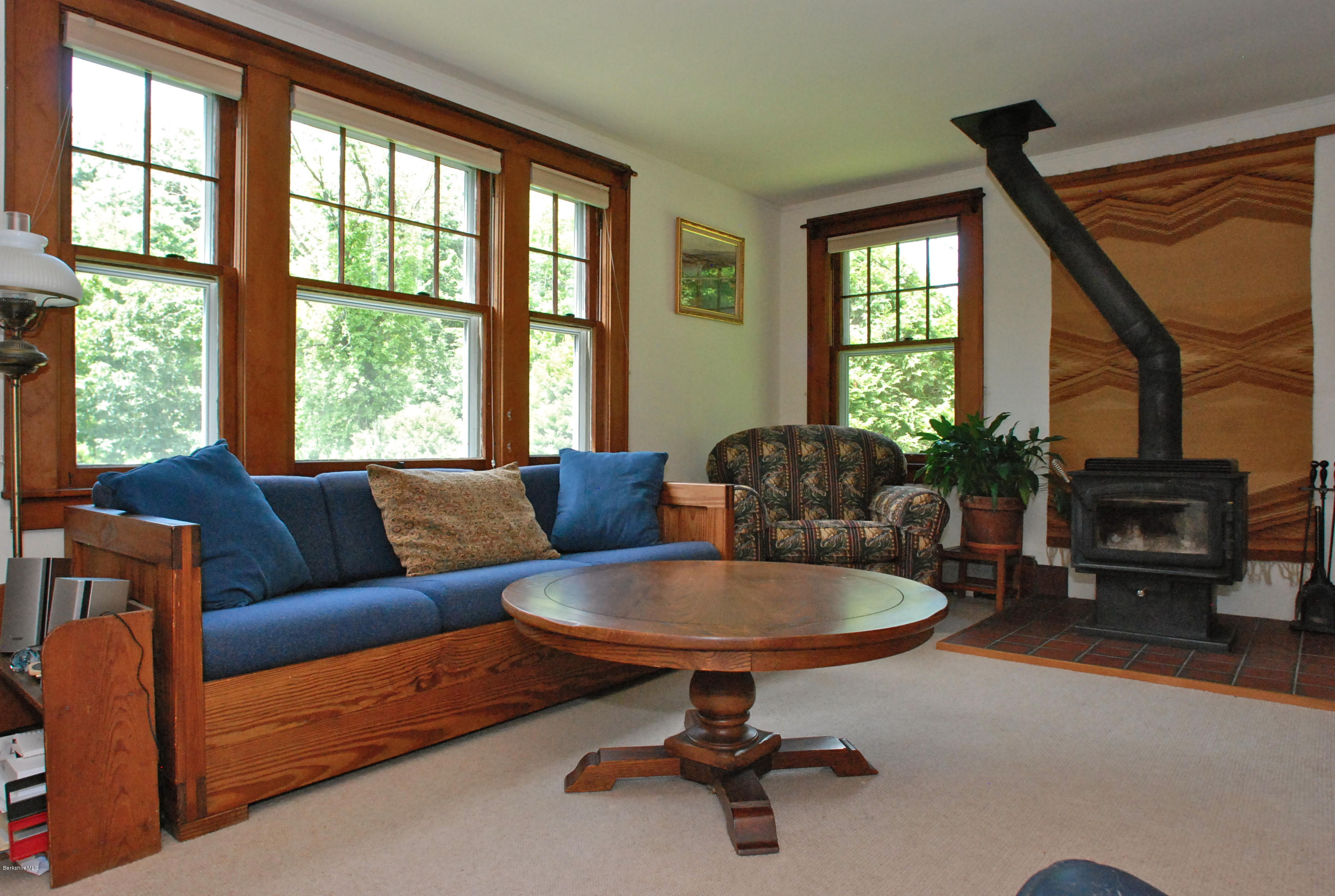 49 River Road Monterey, MA 01245 - Photo 13 of 43 a living room with furniture a fireplace and a table