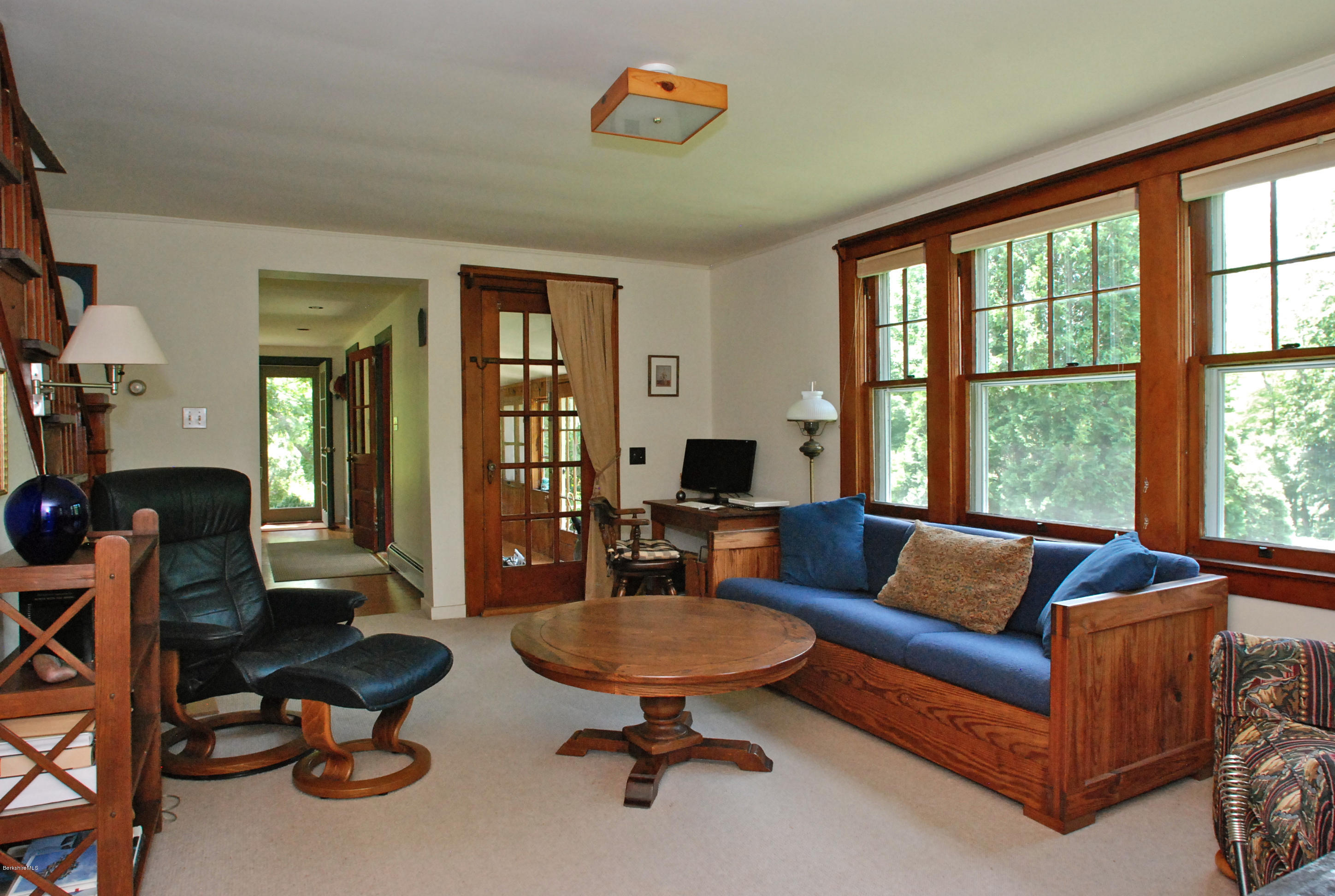49 River Road Monterey, MA 01245 - Photo 14 of 43 a living room with furniture a floor to ceiling window and a flat screen tv