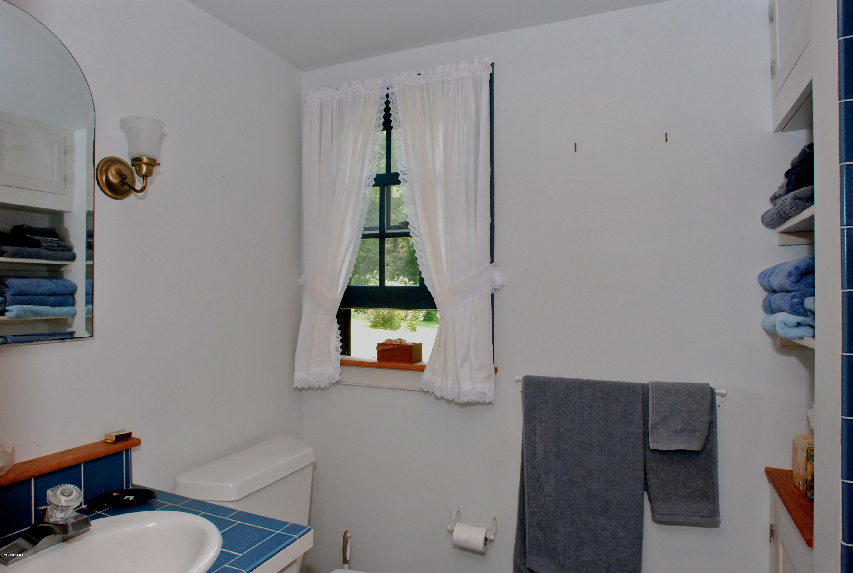 49 River Road Monterey, MA 01245 - Photo 17 of 43 a bathroom with a toilet sink and mirror