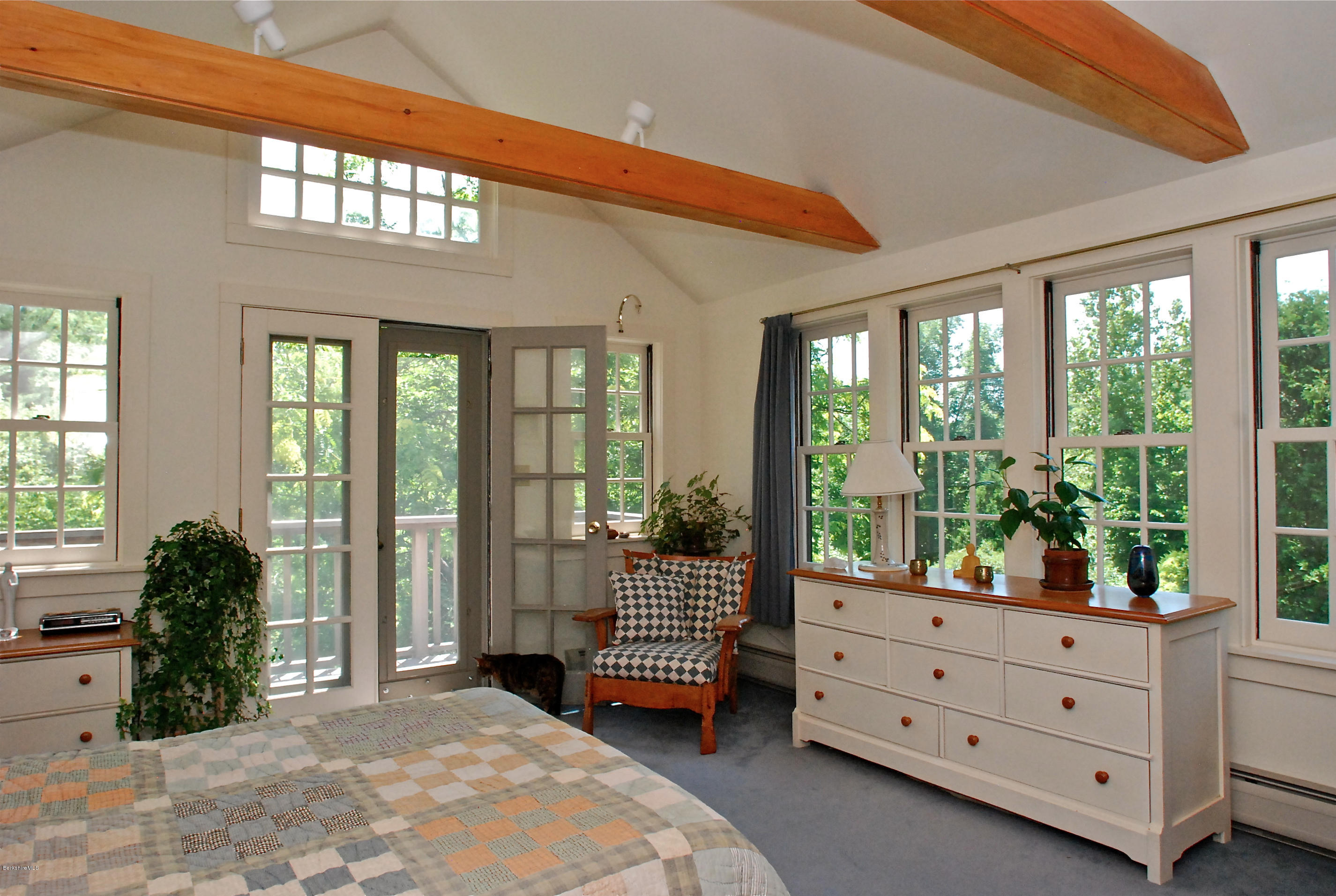 49 River Road Monterey, MA 01245 - Photo 27 of 43 a bedroom with a bed and large windows