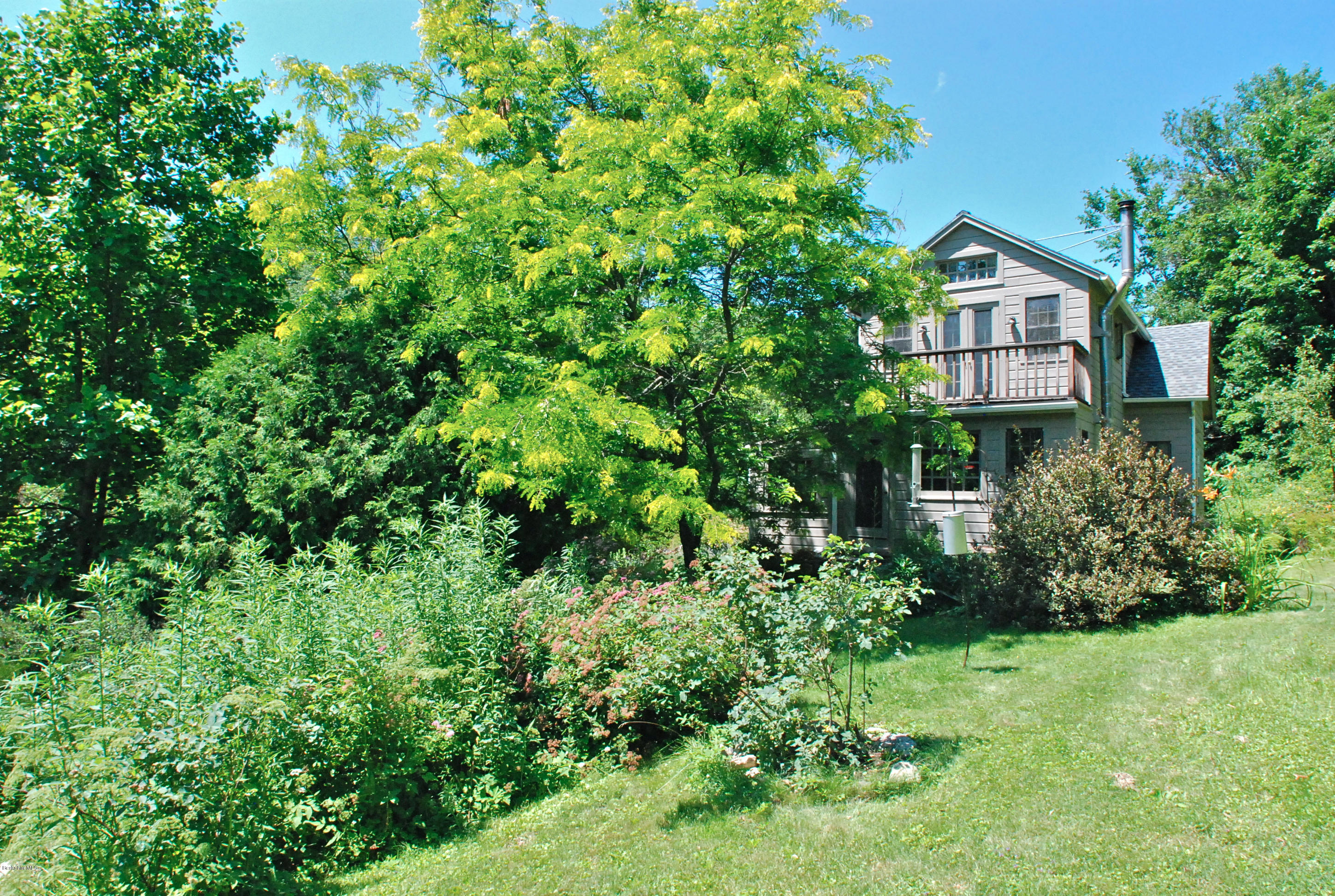 49 River Road Monterey, MA 01245 - Photo 33 of 43 a view of a house with a tree in a yard