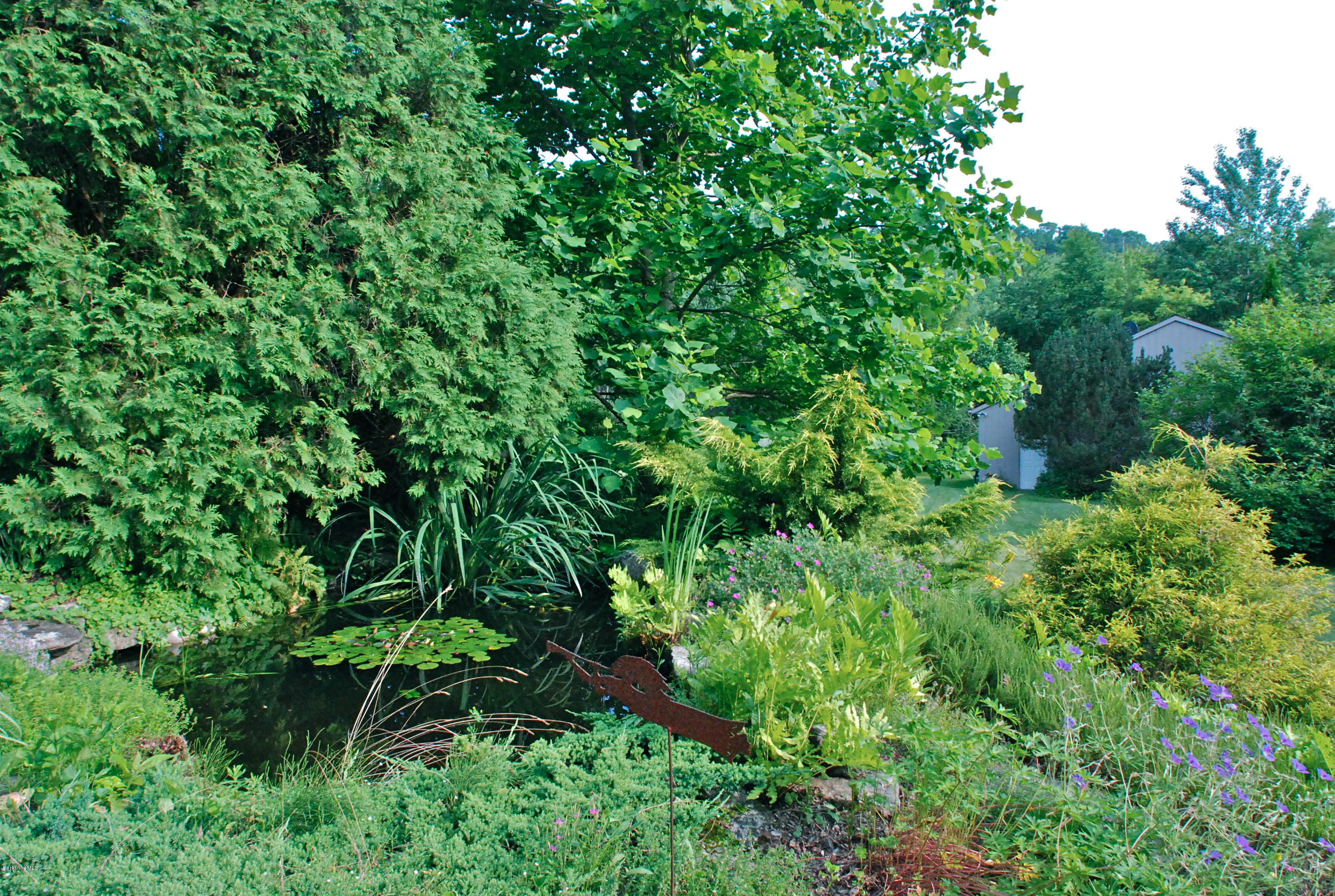 49 River Road Monterey, MA 01245 - Photo 37 of 43 an aerial view of a house with a lush green forest