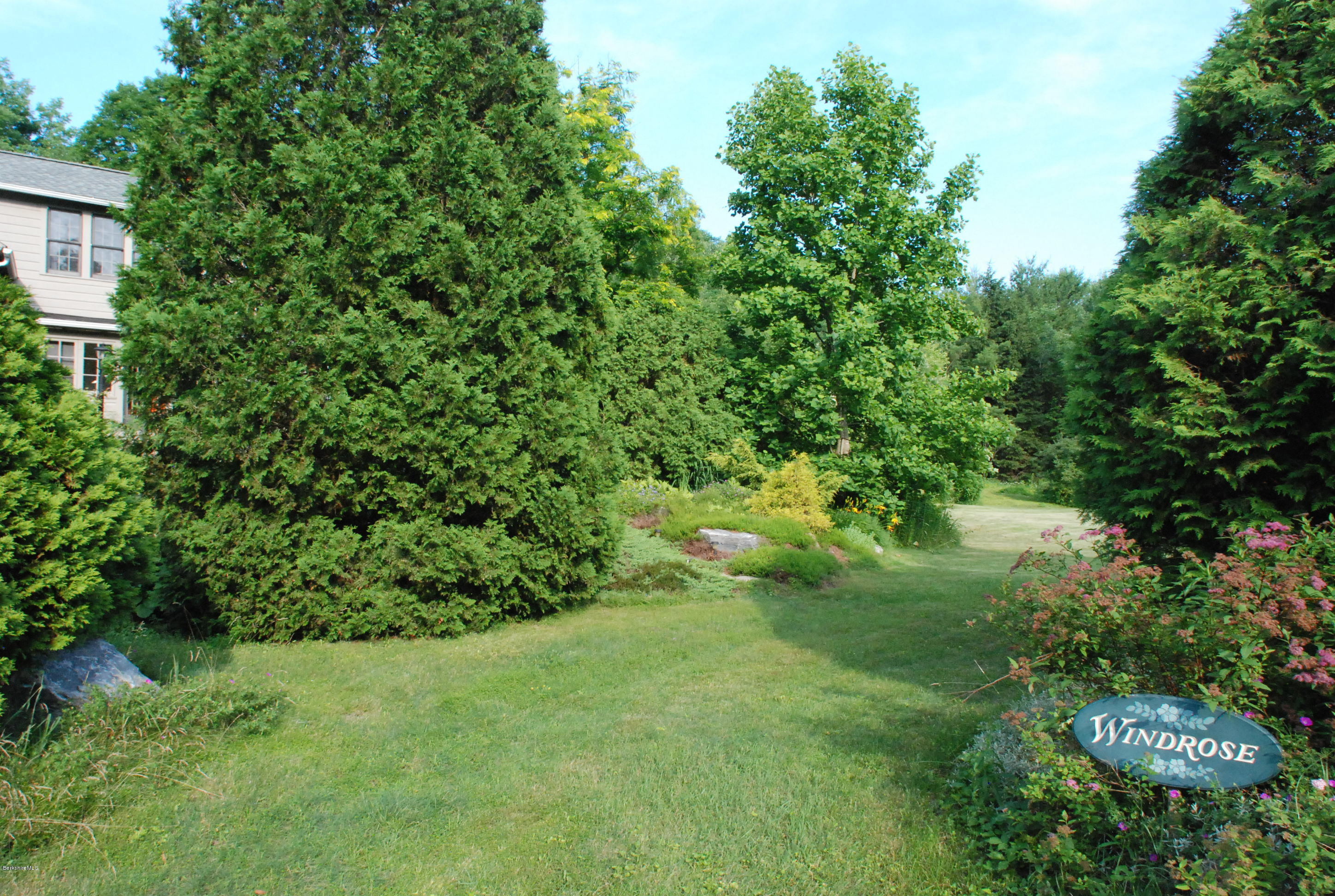 49 River Road Monterey, MA 01245 - Photo 43 of 43 a view of a garden with a house