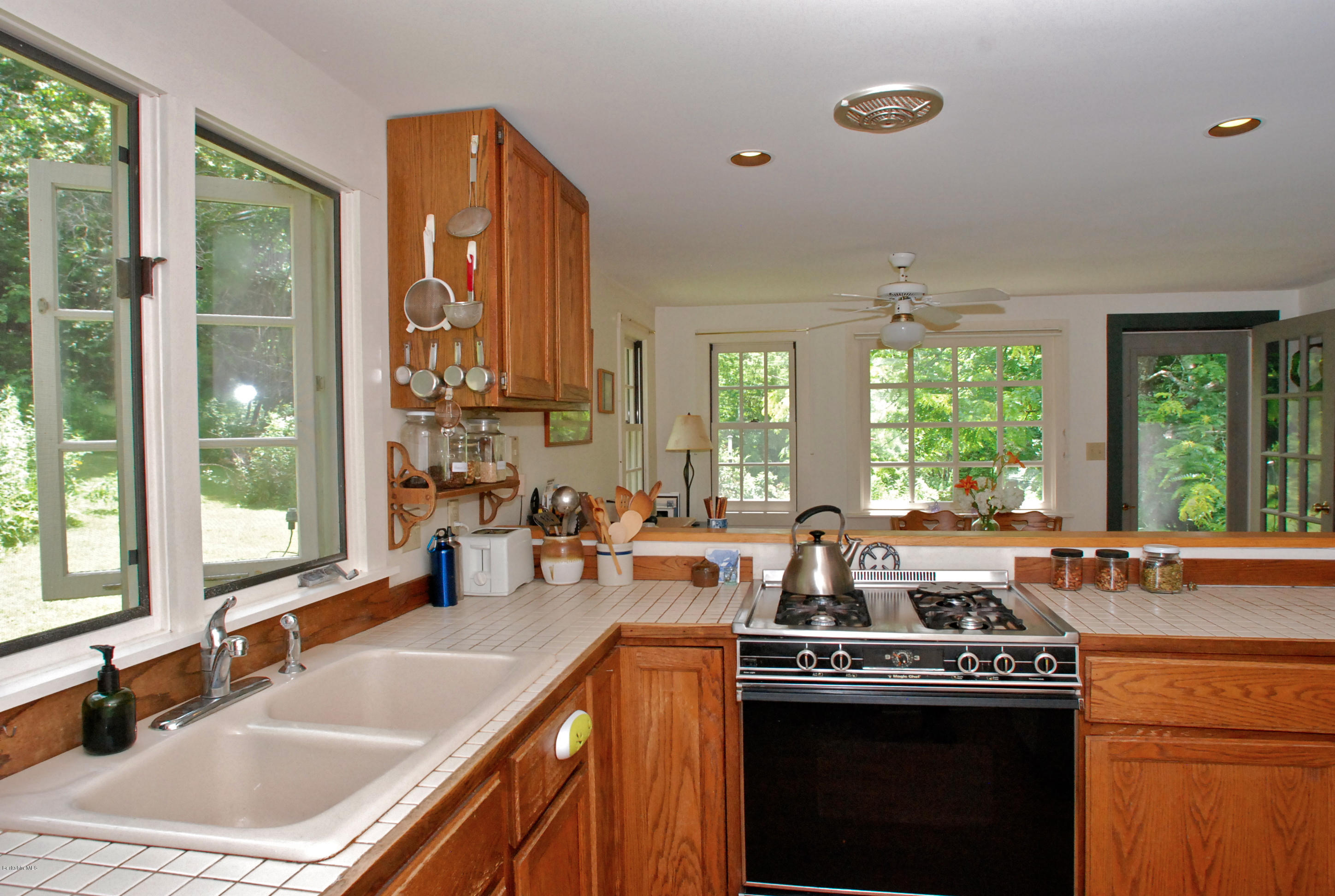 49 River Road Monterey, MA 01245 - Photo 8 of 43 a kitchen with a sink stove and cabinets