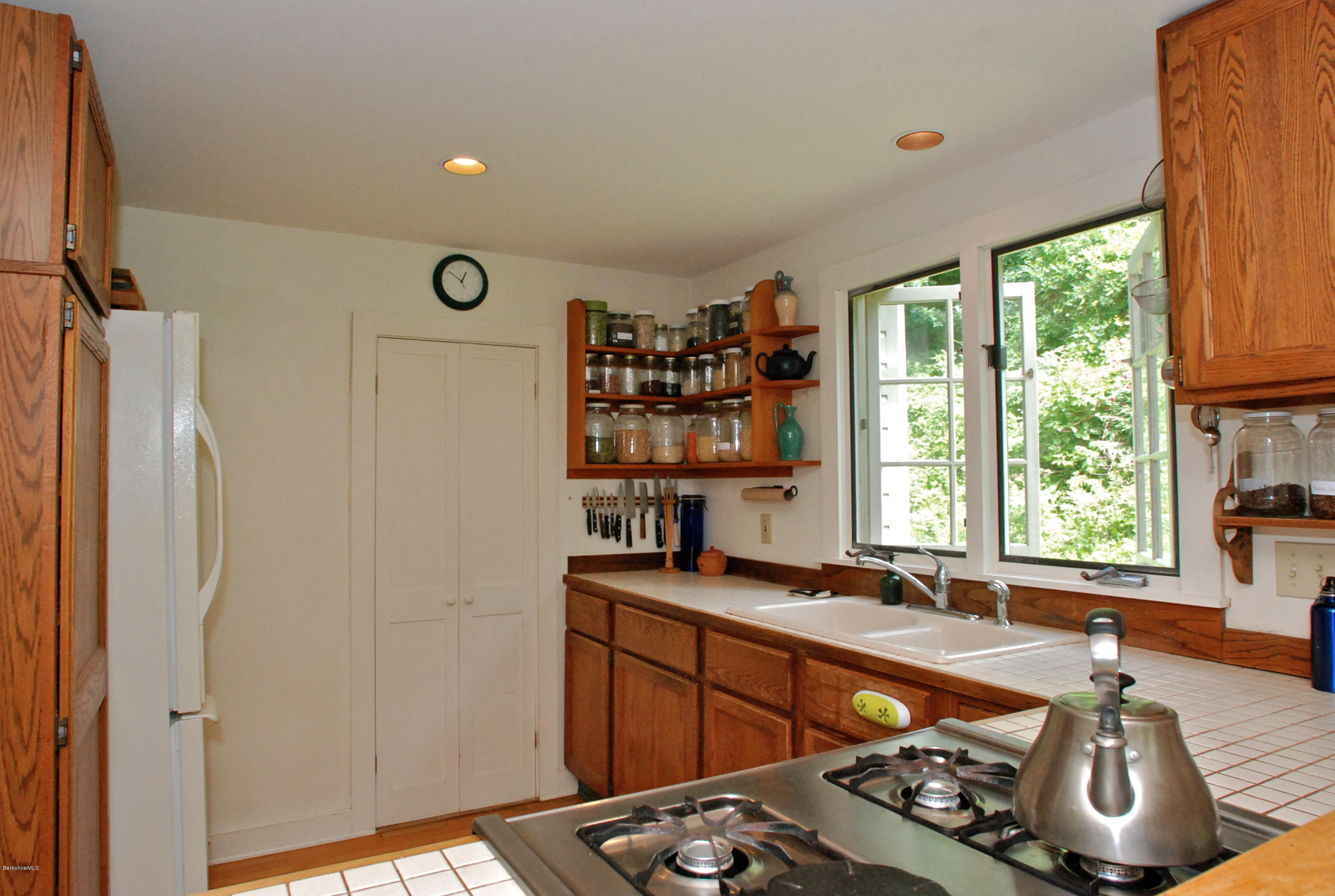 49 River Road Monterey, MA 01245 - Photo 9 of 43 a kitchen with stainless steel appliances granite countertop a sink stove and refrigerator