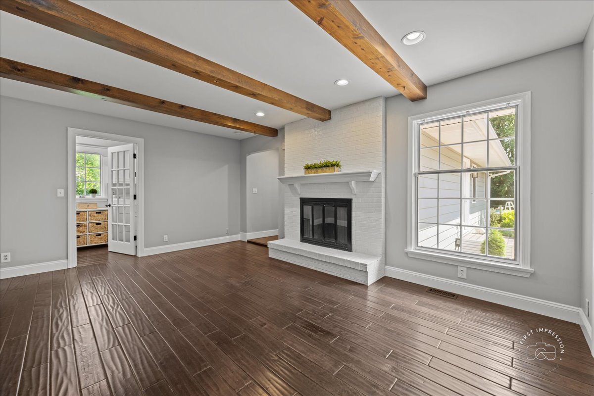51 Burgess Road Geneva, IL 60134 - Photo 12 of 32 an empty room with wooden floor fireplace and windows
