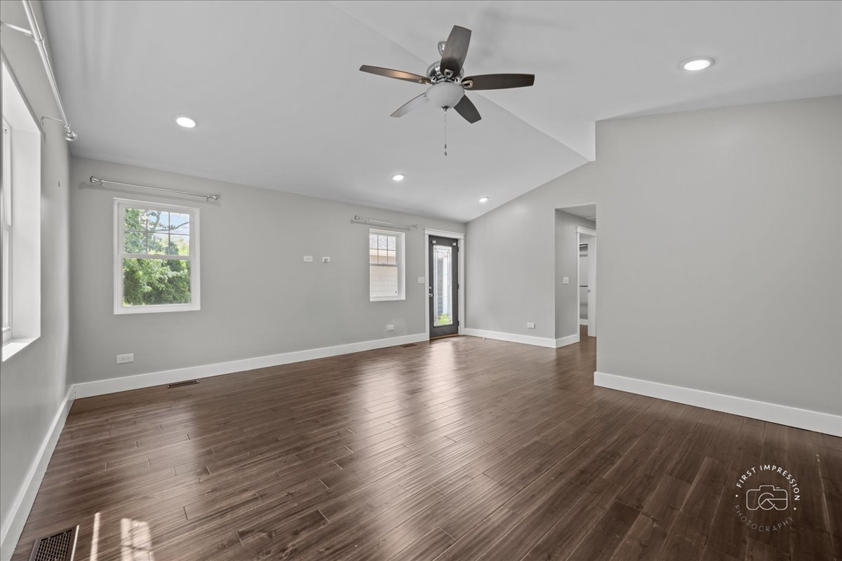 51 Burgess Road Geneva, IL 60134 - Photo 15 of 32 a view of an empty room with a window and wooden floor