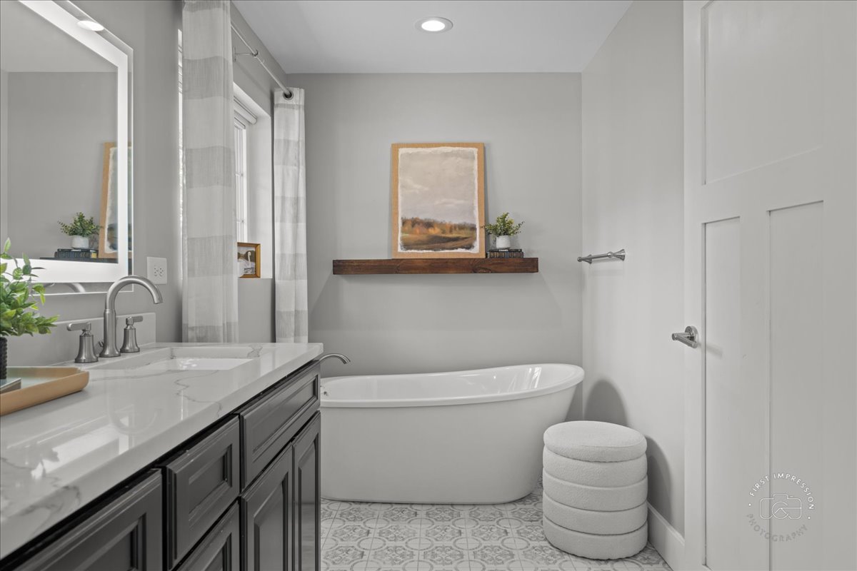 51 Burgess Road Geneva, IL 60134 - Photo 17 of 32 a bathroom with a granite countertop toilet sink and mirror