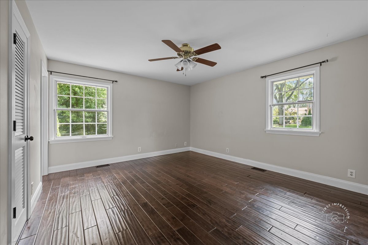 51 Burgess Road Geneva, IL 60134 - Photo 19 of 32 a view of an empty room with wooden floor and a window