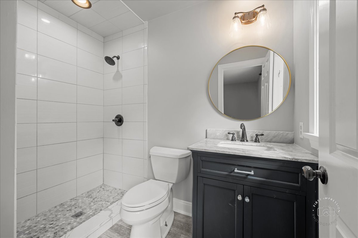 51 Burgess Road Geneva, IL 60134 - Photo 20 of 32 a bathroom with a toilet a sink and mirror