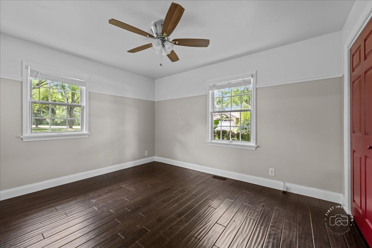 51 Burgess Road Geneva, IL 60134 - Photo 21 of 32 a view of an empty room with wooden floor and a window