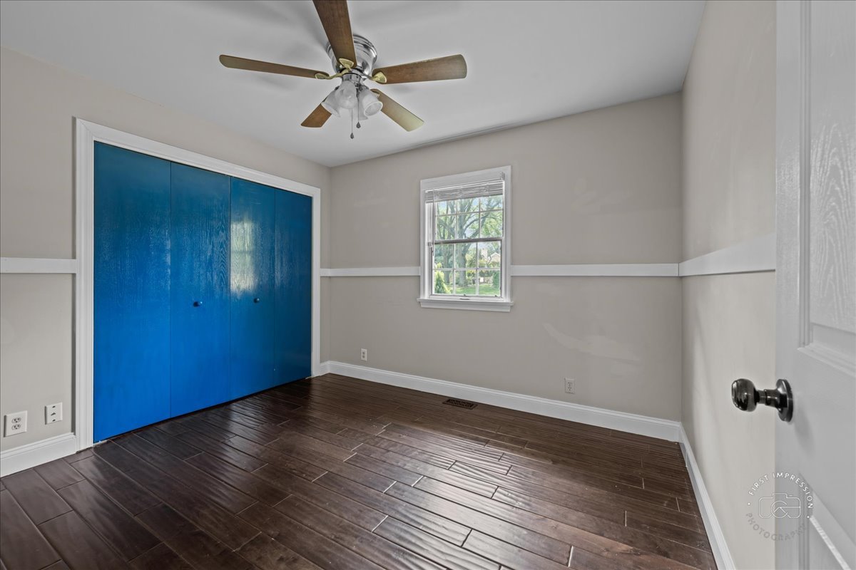 51 Burgess Road Geneva, IL 60134 - Photo 22 of 32 an empty room with wooden floor fan and windows