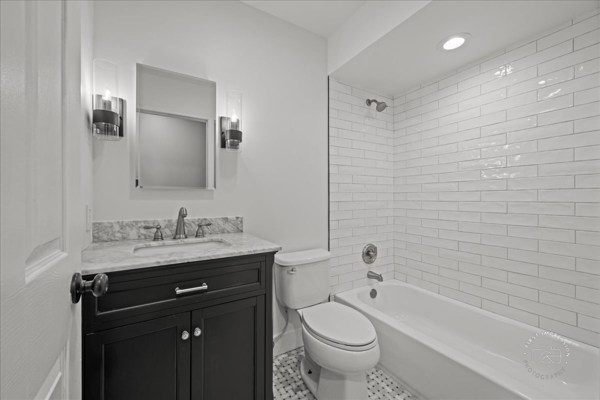 51 Burgess Road Geneva, IL 60134 - Photo 23 of 32 a bathroom with a granite countertop sink toilet and shower