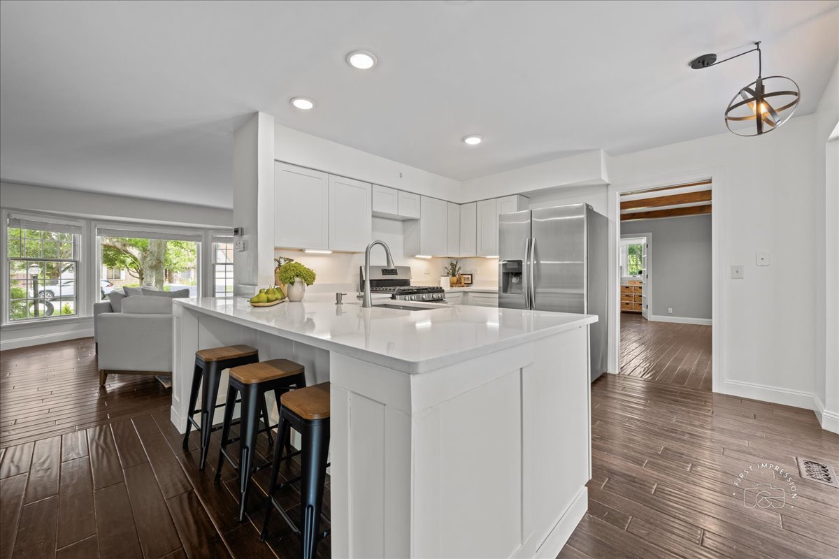 51 Burgess Road Geneva, IL 60134 - Photo 8 of 32 a kitchen with counter top space cabinets and wooden floor
