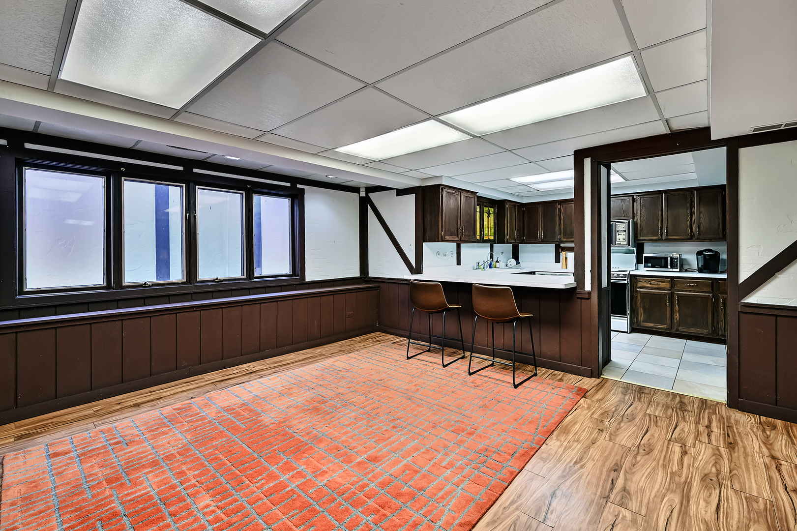 803 Merry Lane Oak Brook, IL 60523 - Photo 29 of 39 a living room with stainless steel appliances kitchen island granite countertop a large kitchen island a stove a sink and a dishwasher with wooden floor