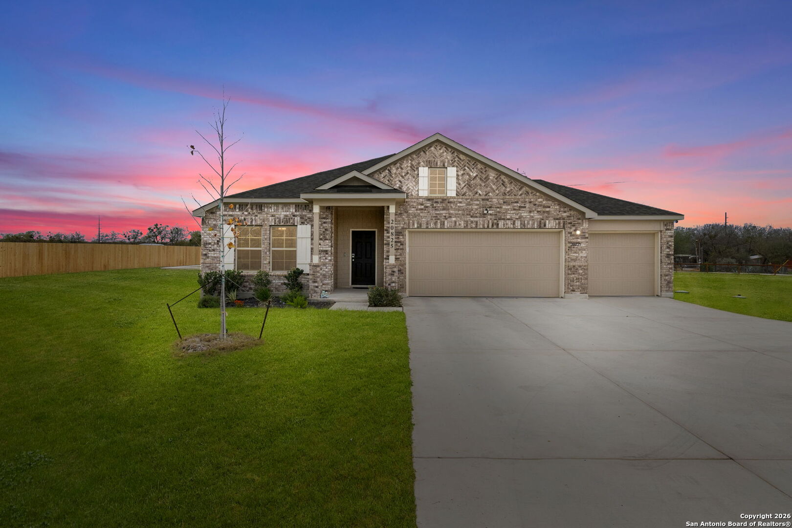 20825 Pleasanton Road San Antonio, TX 78264 - Photo 2 of 33 a front view of a house with a yard and garage