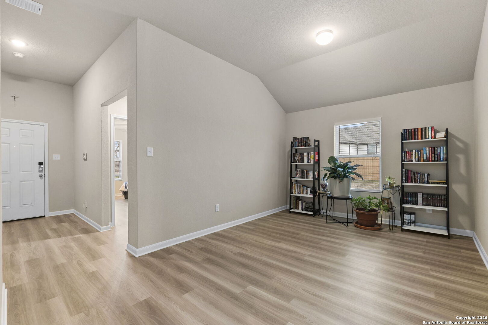 20825 Pleasanton Road San Antonio, TX 78264 - Photo 5 of 33 wooden floor in an empty room with a window