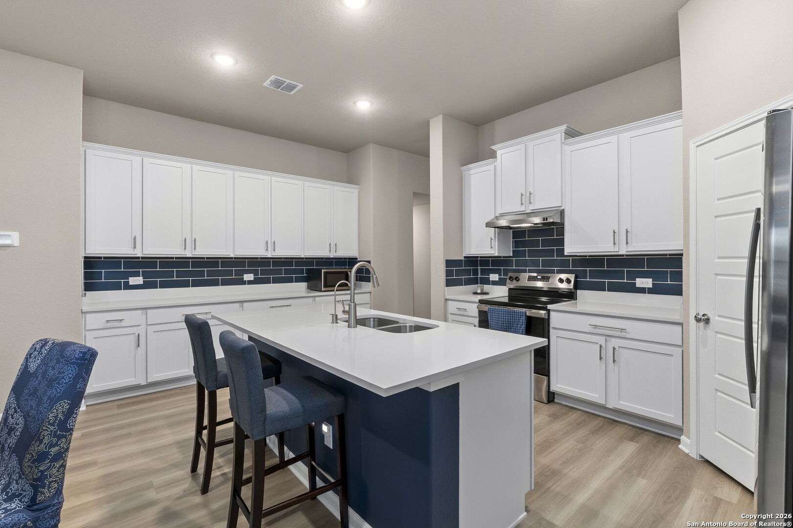 20825 Pleasanton Road San Antonio, TX 78264 - Photo 8 of 33 a kitchen that has a lot of cabinets in it with appliances and wooden floor
