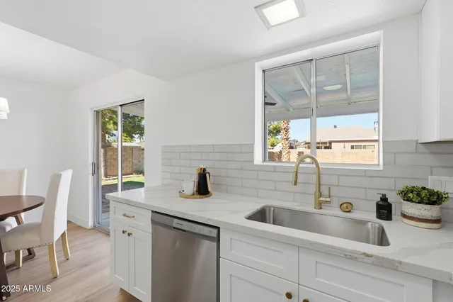 a kitchen with a sink cabinets and window