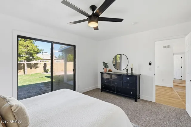 a bedroom with a bed closet and window