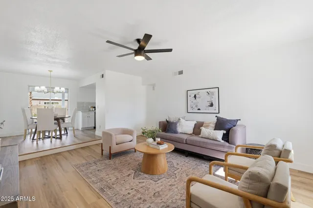 a living room with furniture and a wooden floor