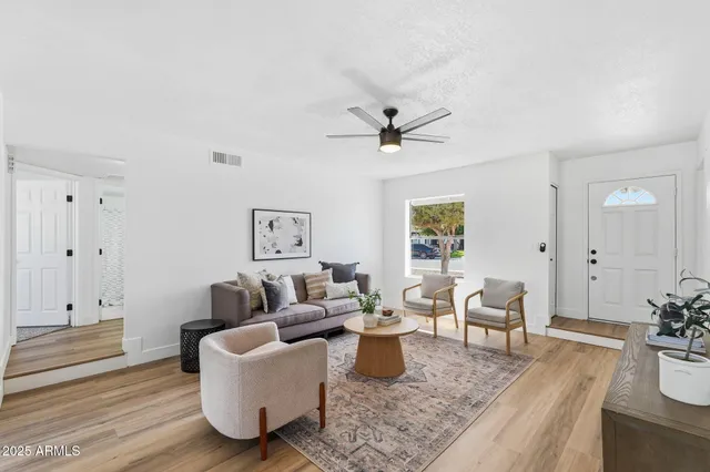 a living room with furniture and wooden floor
