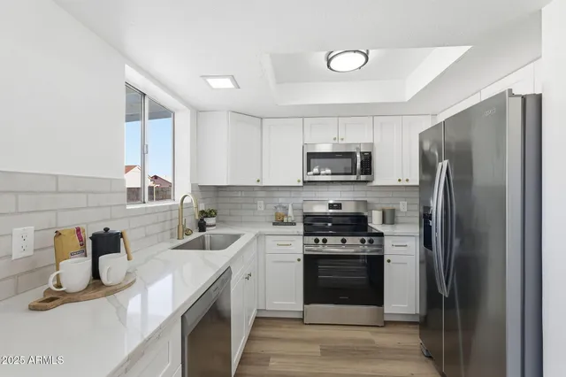 a kitchen with a sink stove and refrigerator