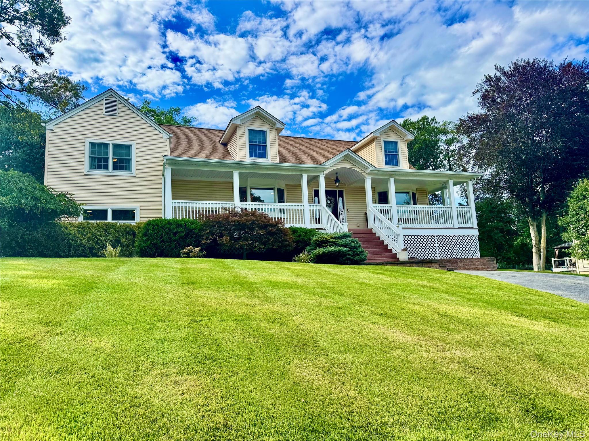 87 Pinto Road Pearl River, NY 10965 - Photo 1 of 1 View of front of house with covered porch, a front yard, roof with shingles, and stairs