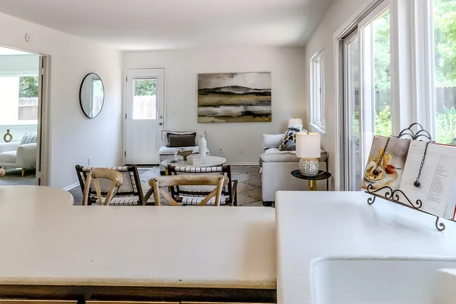 a living room with fireplace furniture and a large window