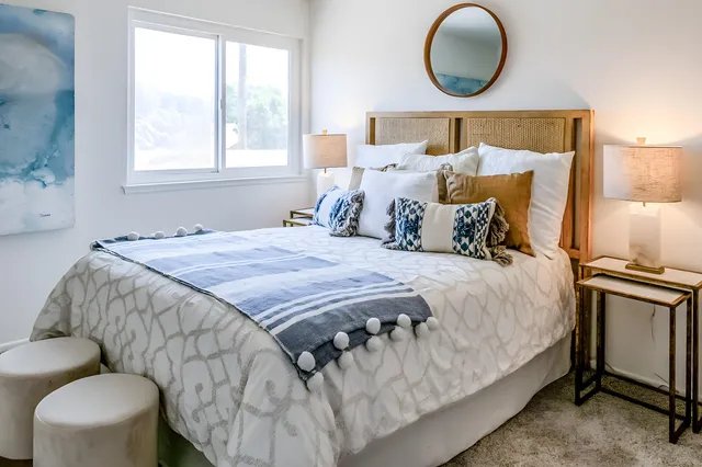 a bedroom with bed and wooden floor