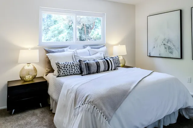 a bedroom with a bed and window