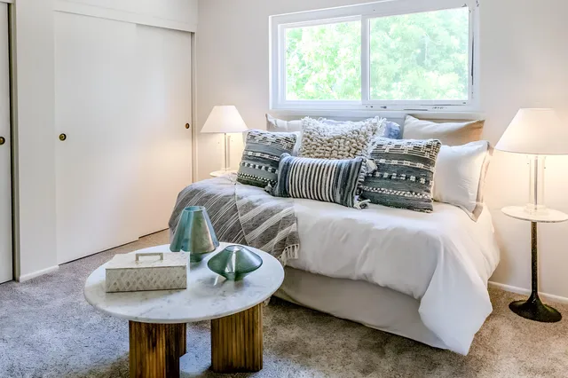 a bedroom with bed and a window