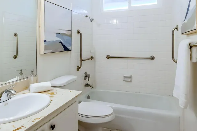 a bathroom with a sink toilet and shower
