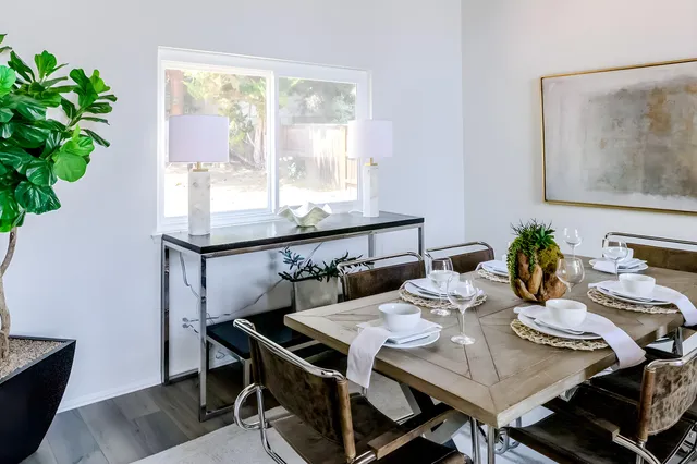 a view of a dining room with furniture window and wooden floor