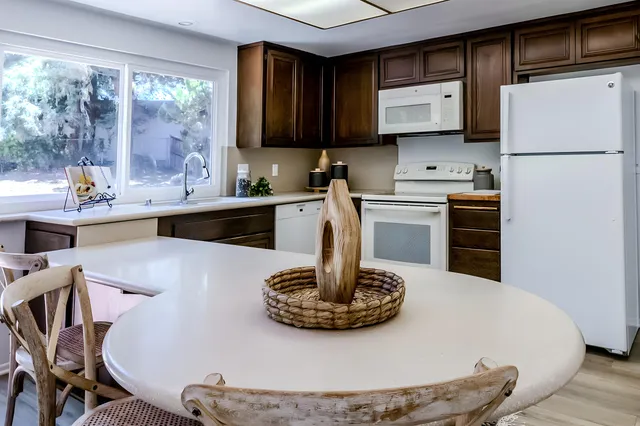 a kitchen with a sink appliances and cabinets