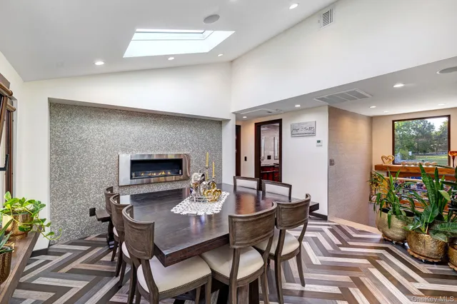 a view of a dining room with furniture and a potted plant