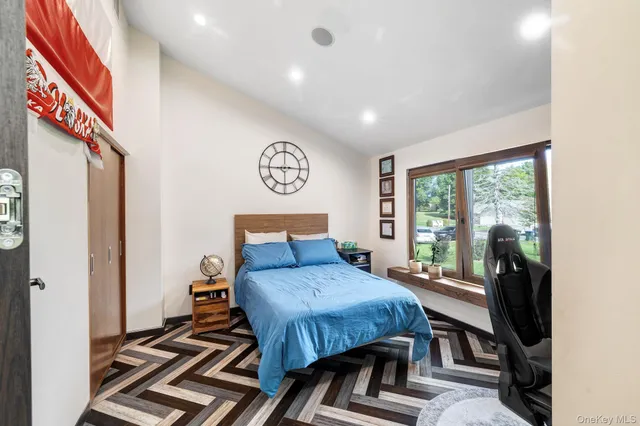 a bedroom with a bed and a window