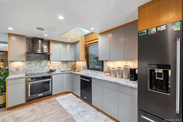 a kitchen with granite countertop stainless steel appliances and wooden cabinets