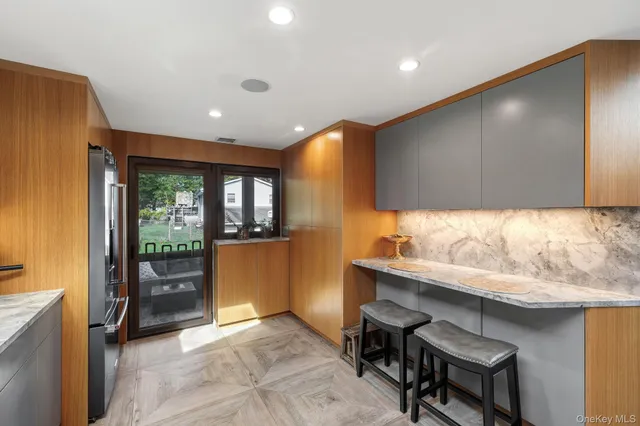 a view of a hallway with cabinet and a flat screen tv