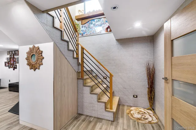 a view of entryway and hall with wooden floor