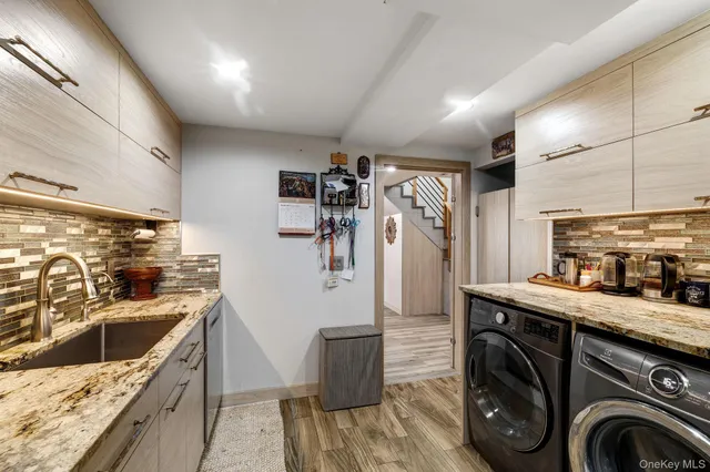 a kitchen with a sink a stove and washer