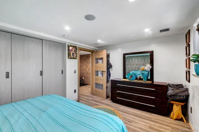 a bedroom with a bed and a painting on the wall