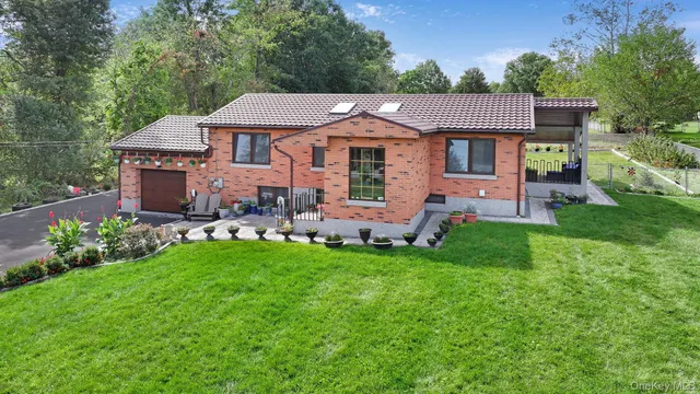 a front view of a house with a garden