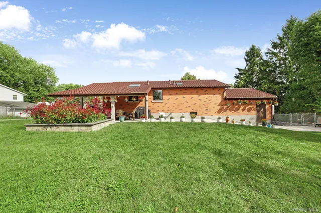 a view of a garden with plants and large trees