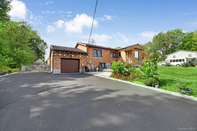 a house view with a sitting space and garden