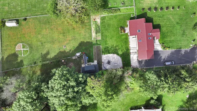 a view of house with swimming pool and garden