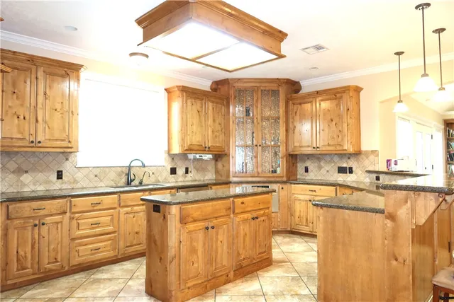 a bathroom with a granite countertop sink and a large mirror