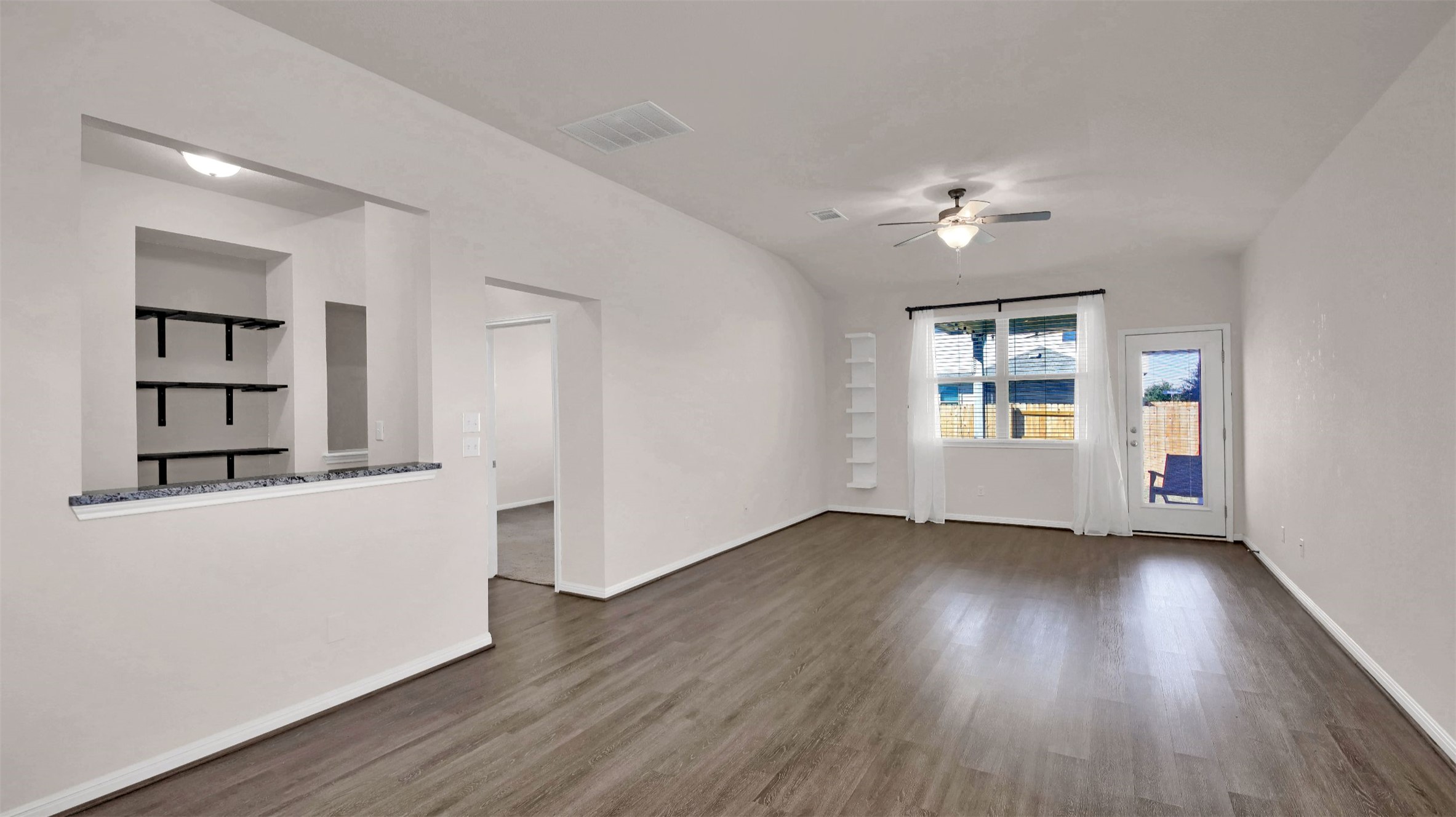 19032 Quebrada Drive Pflugerville, TX 78660 - Photo 12 of 29 a view of a room with wooden floors and ceiling fan