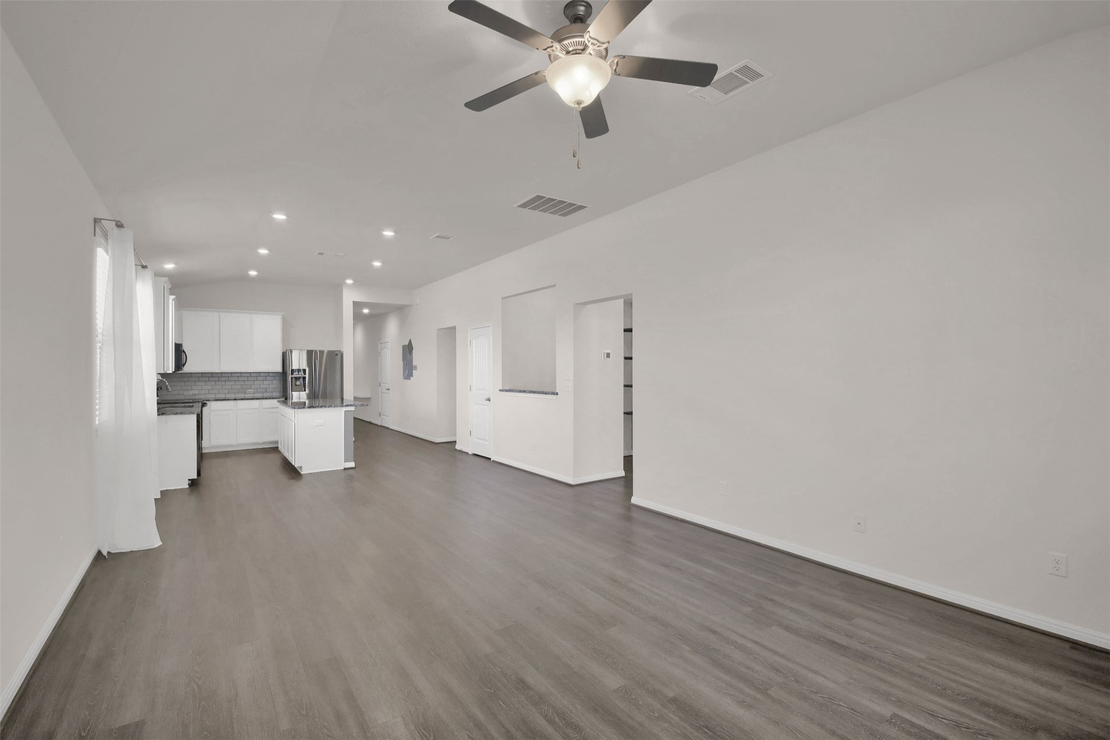 19032 Quebrada Drive Pflugerville, TX 78660 - Photo 13 of 29 a view of an empty room with a kitchen